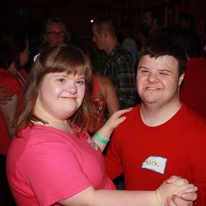 Man & woman with Down Syndrome dancing