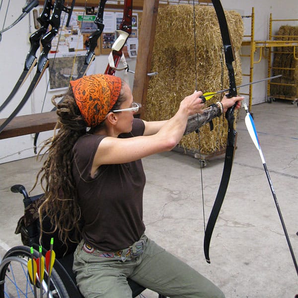 Woman in a wheelchair doing archery